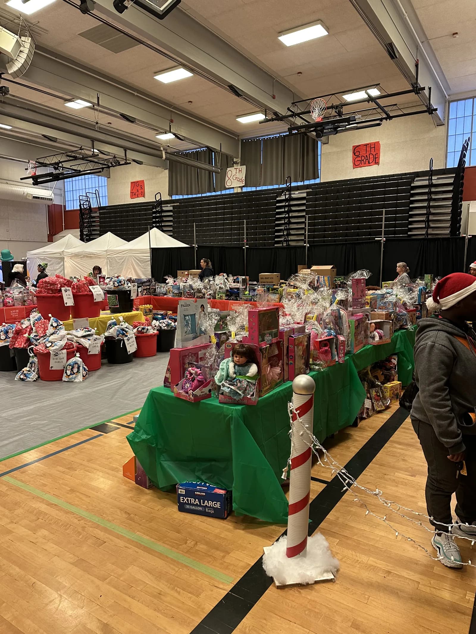 Tables of wrapped gifts at the FW Cares community toy drive